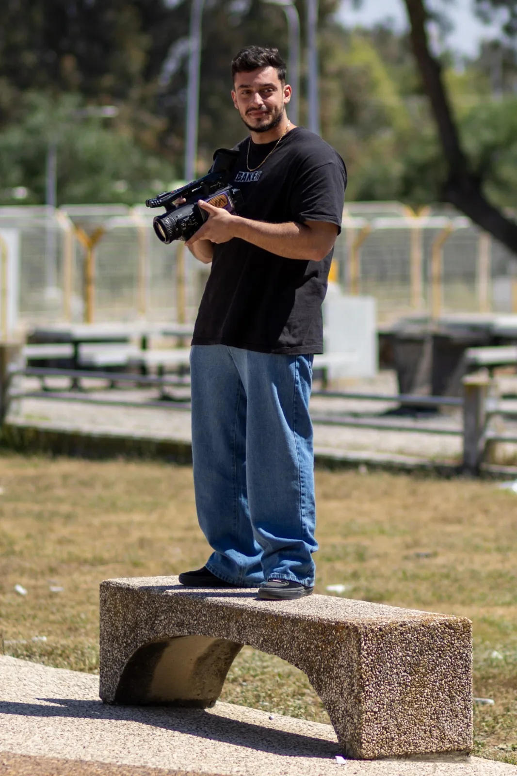 Arthur holding his camera at the skatepark