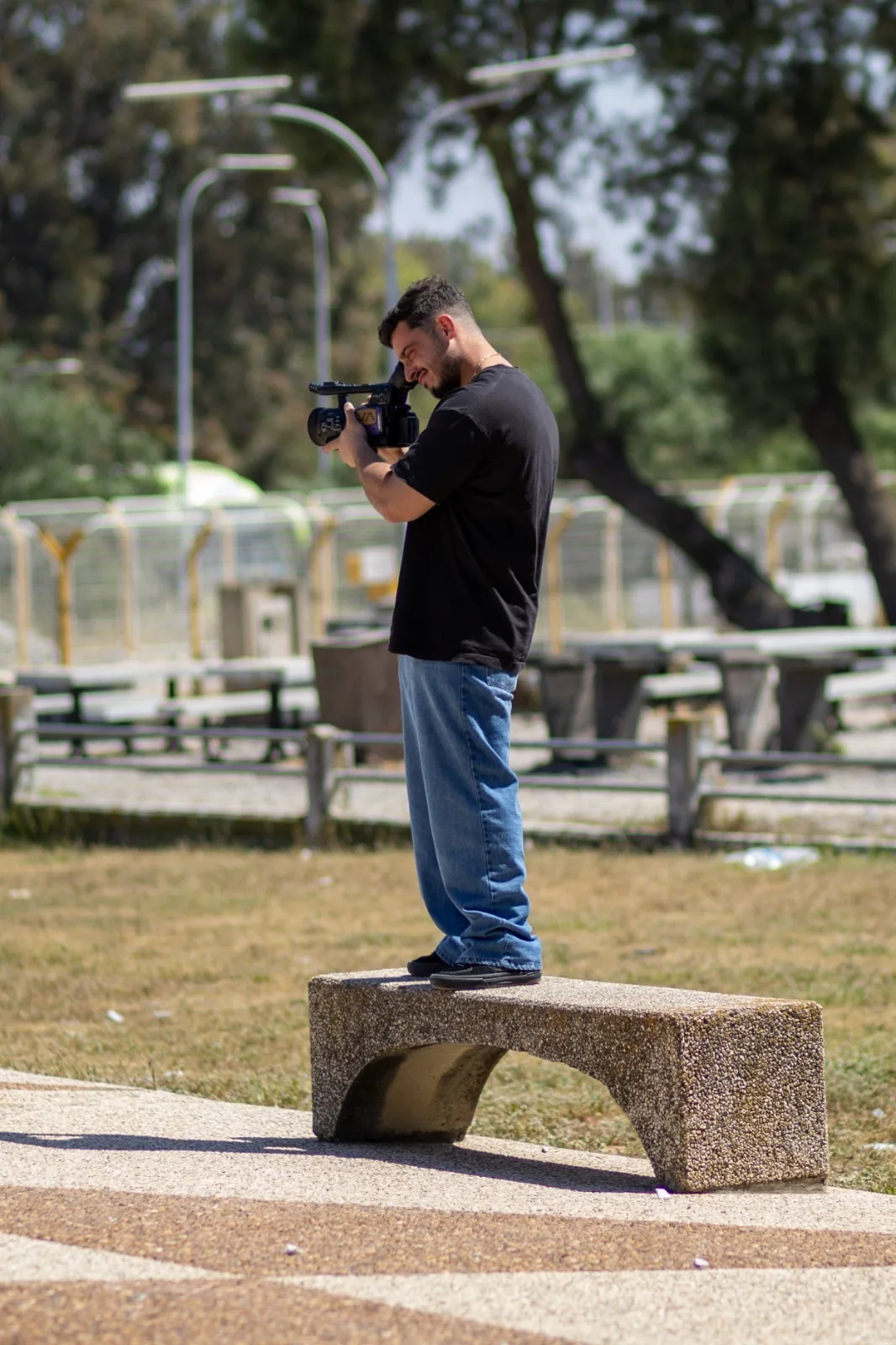 Arthur looking through his camera at the skatepark