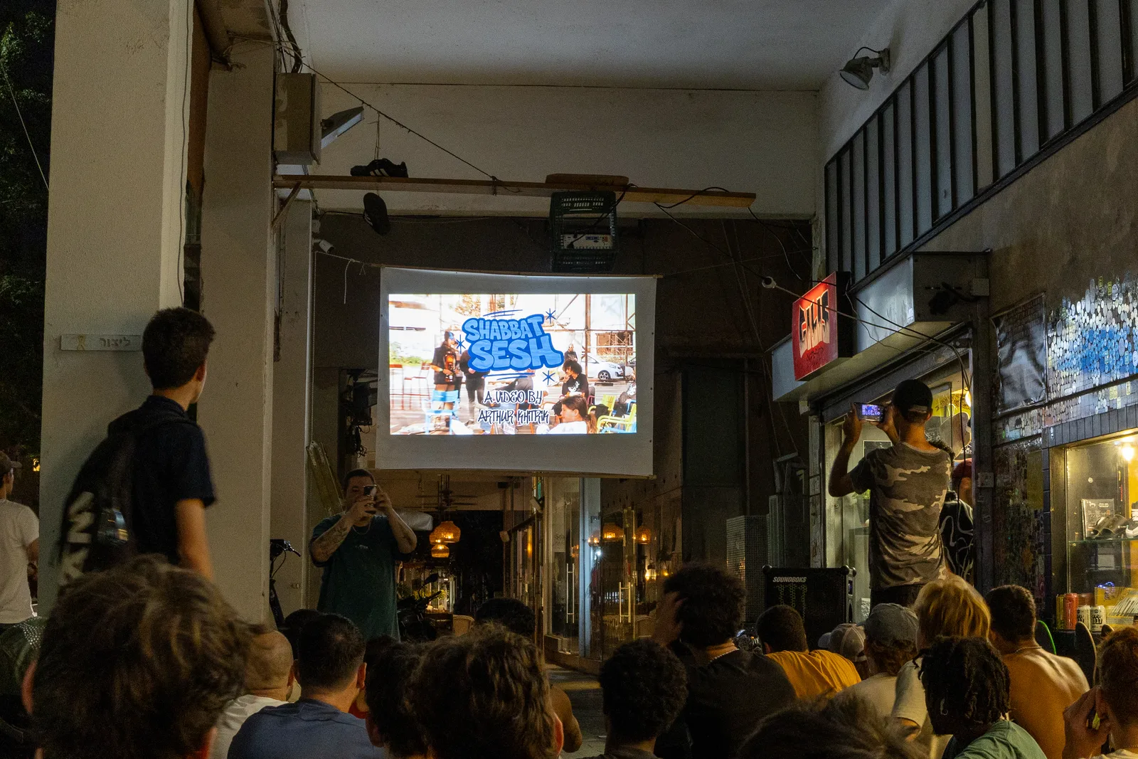 SHABBAT SESH projected above the audience at Gilis Skateshop