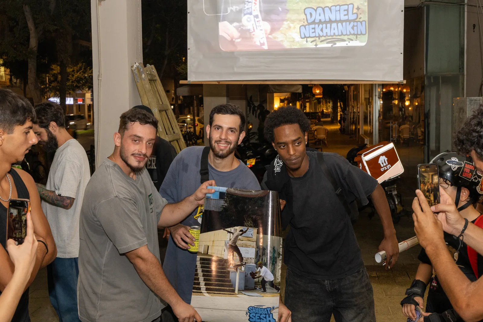 The crew holding a skate photograph at the premiere
